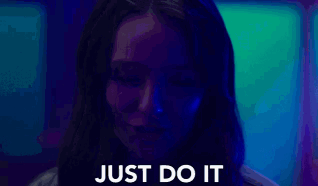 a close up of a woman 's face with the words `` just do it '' written on the screen .