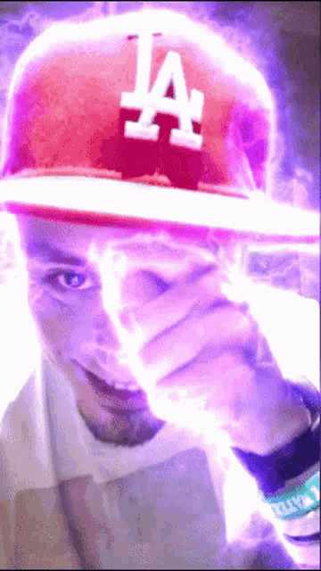 a man wearing a la hat is covering his eyes