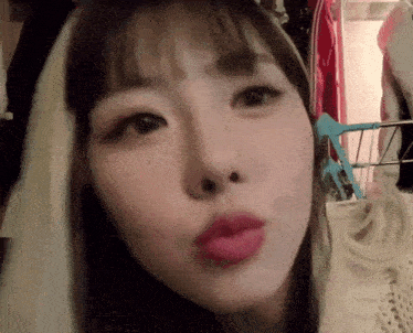 a close up of a woman 's face with a red lip