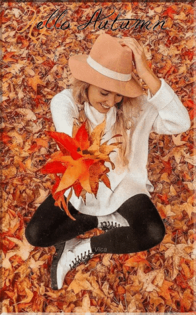 a woman in a hat sits in a pile of leaves with the words hello autumn written on the bottom