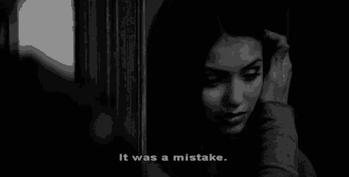 a black and white photo of a woman with the words " it was a mistake " below her