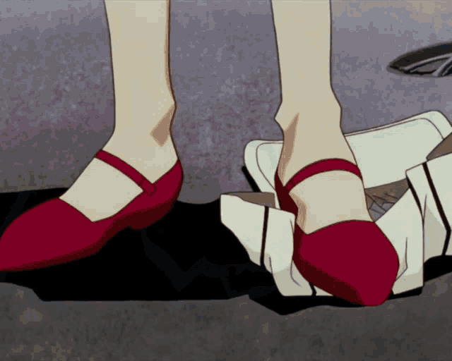 a woman wearing red shoes is standing next to another pair of shoes