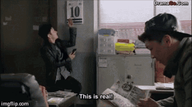 a man is reading a newspaper while another man hangs a sign that says 10