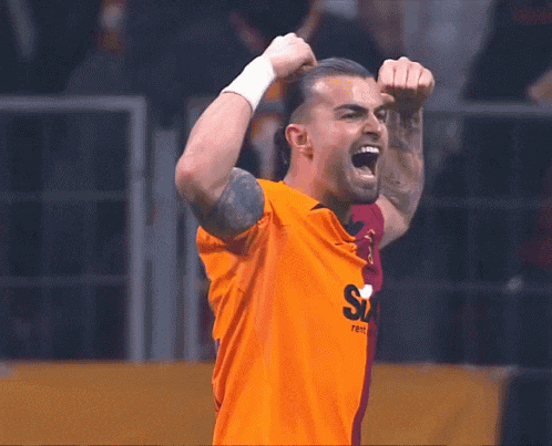 a man in an orange shirt with the letter s on the front
