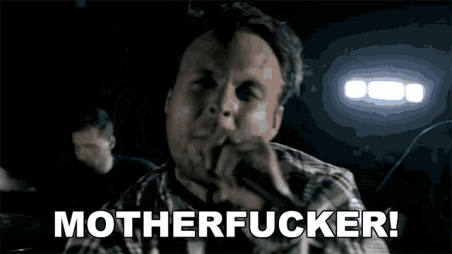 a man is singing into a microphone and the words motherfucker are written below him