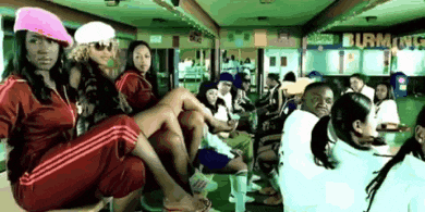 a group of people are sitting in front of a sign that says burton