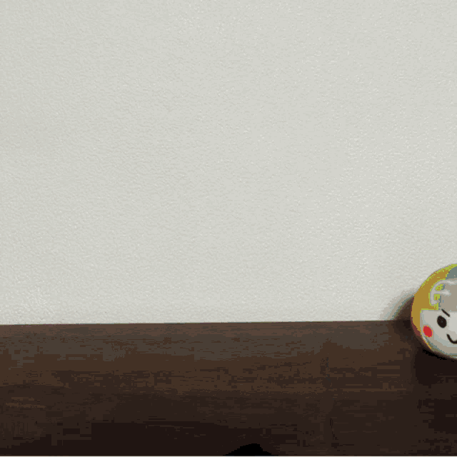 a colorful ball with the letter f on it sits on a table