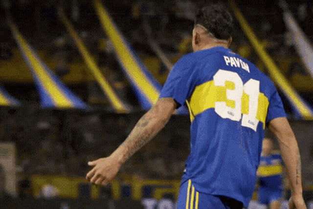 a soccer player wearing a blue jersey with the number 31 on the back