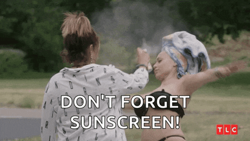 a woman applying sunscreen to another woman 's face .