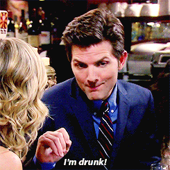 a man in a suit and tie is talking to a woman and says " i 'm drunk "