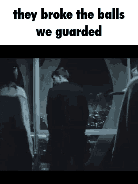 a man in a suit is standing in front of a window with the words `` they broke the balls we guarded '' written on it