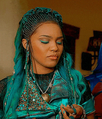 a woman with blue hair is wearing a black top and a necklace