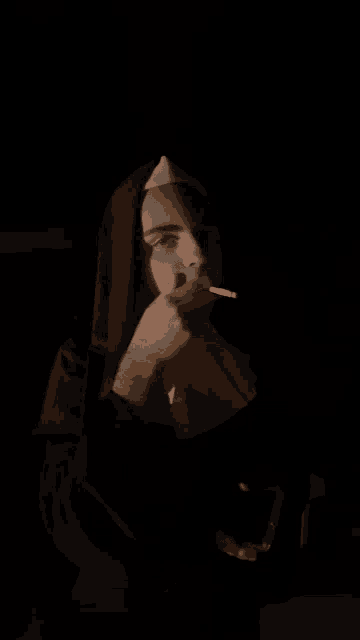 a man dressed as a nun smoking a cigarette