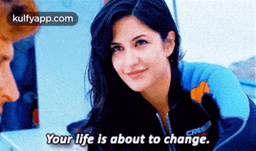 a woman is smiling and talking to a man and says your life is about to change .