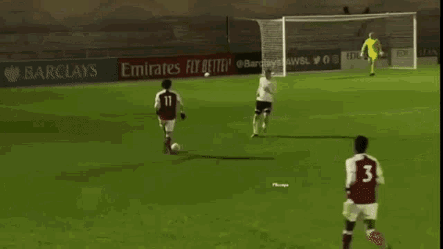 a group of soccer players are playing on a field with ads for mastercard in the background .