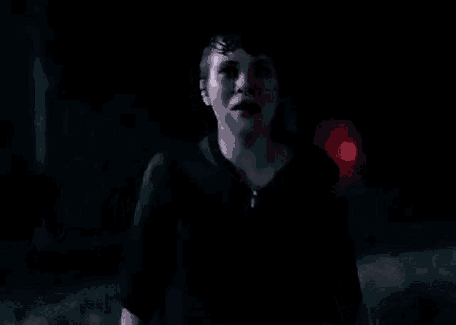 a blurry picture of a person in a dark room .