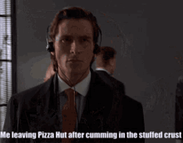 a man in a suit and tie is wearing headphones