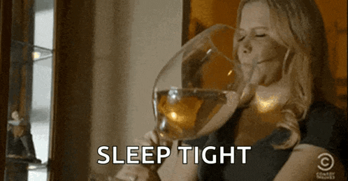 a woman drinking a large glass of wine with the words sleep tight behind her