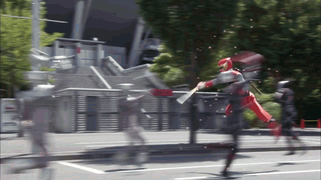 a blurred image of a person in a red costume holding a bat
