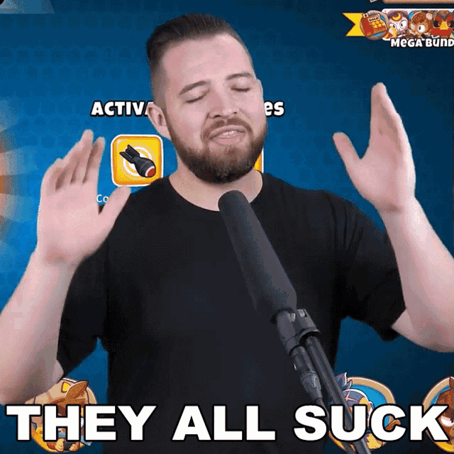 a man in front of a microphone with the words they all suck on the bottom