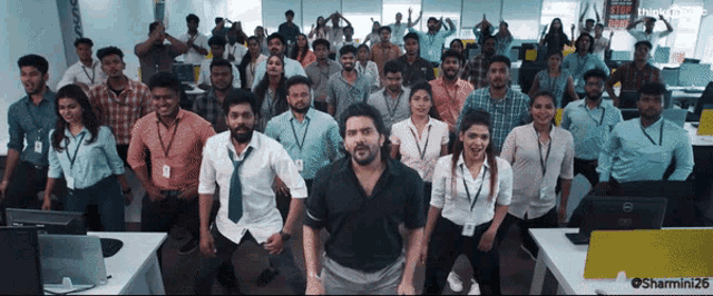 a group of people standing in an office with a dell computer