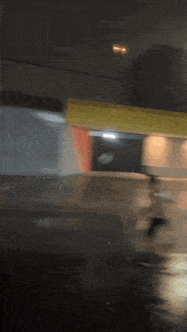 a blurred image of a building with a red light on the top