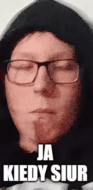 a man wearing glasses and a hood has the words ja kiedy siur written below him