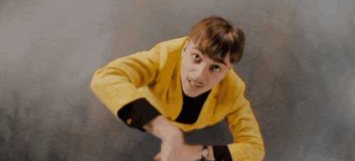 a man wearing a yellow jacket and a watch