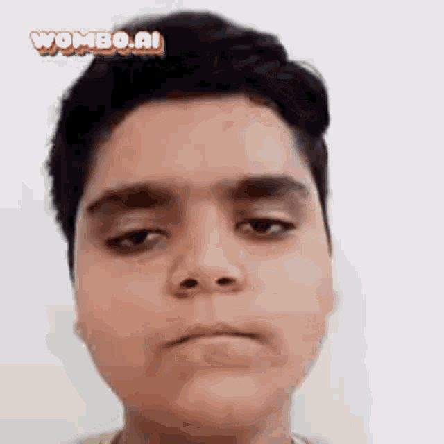 a close up of a boy 's face with the words wombo.nl on the bottom right