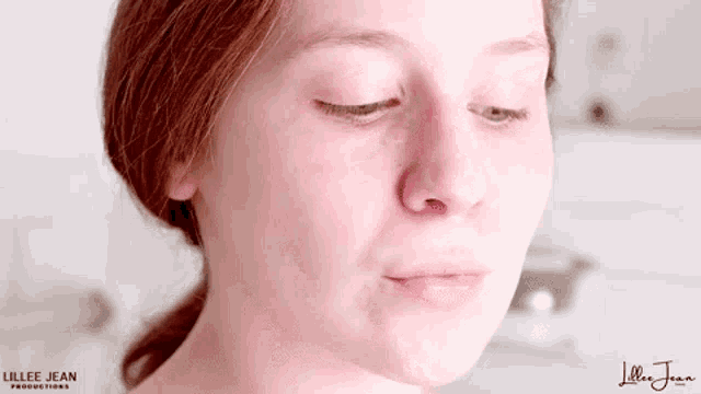 a close up of a woman 's face without makeup .