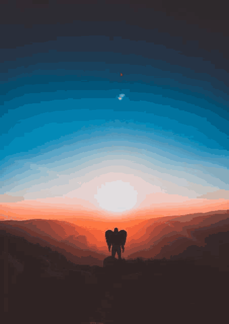 a silhouette of a person with angel wings standing on a hill at sunset
