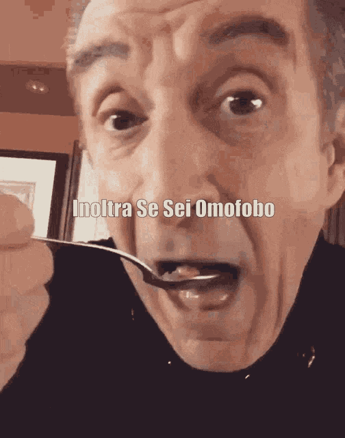 a man is holding a spoon in his mouth with the words inoltre se sei omofobo written above him