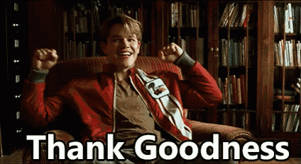 a man in a red jacket is sitting in a chair with his arms in the air and the words thank goodness above him .