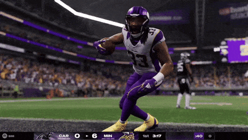 a football player in a purple jersey with the number 23 on it