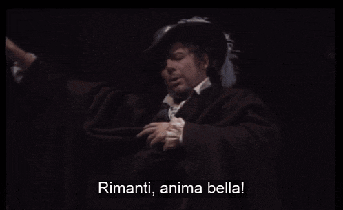 a man in a black cape says ' riminti anima bella '
