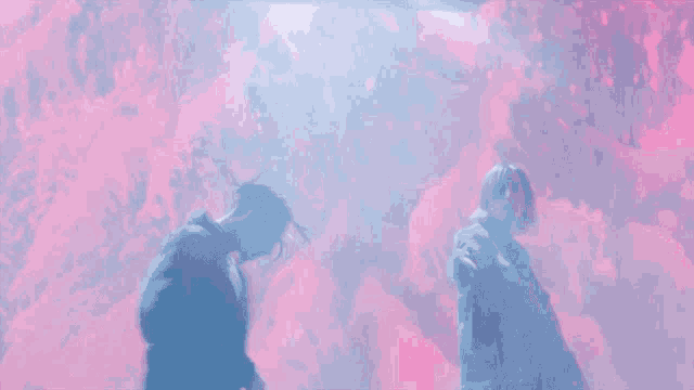 a man and a woman are standing in front of a red background