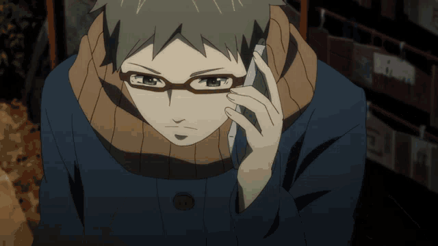 a man wearing glasses is talking on a phone