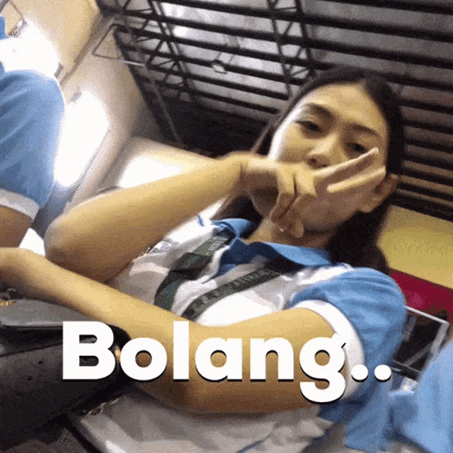 a girl in a blue and white shirt with the word bolang written on it