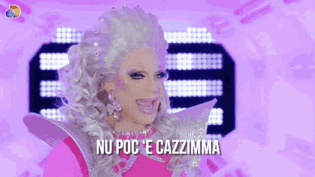 a drag queen in a pink dress with the words nu poc e cazzimma above her