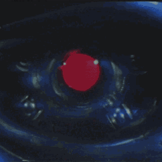 a close up of a red object in the middle of a dark room