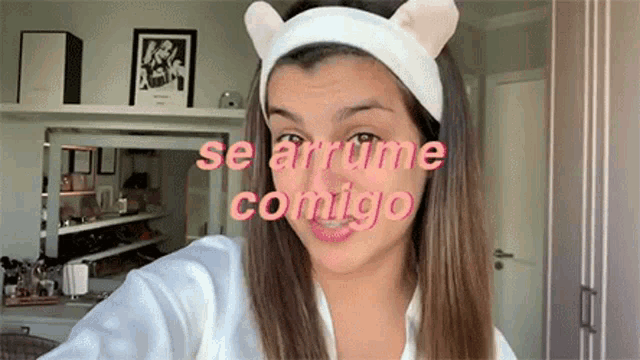 a woman wearing a headband with cat ears is talking to someone .