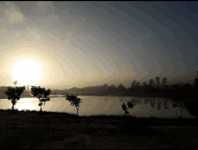 the sun is setting over a body of water