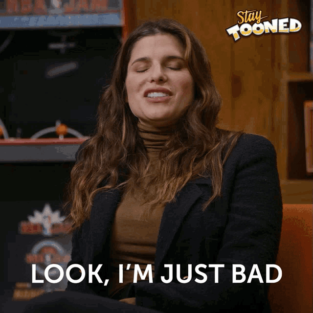 a woman says look i 'm just bad in front of an arcade machine