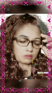 a woman wearing glasses is surrounded by hearts and a hype text watermark