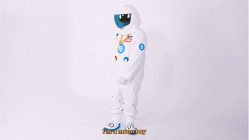a man dressed as an astronaut is wearing a helmet and a gold chain around his neck