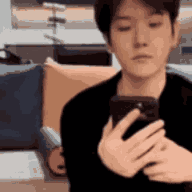 a man is taking a selfie with his phone .