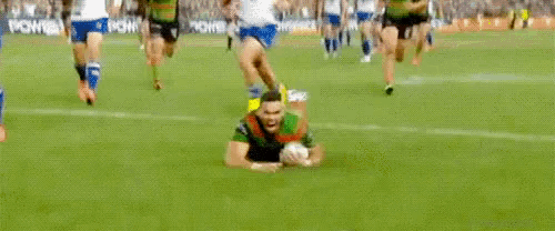 a man is getting ready to run on a rugby field .
