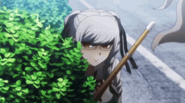 a girl with glasses is holding a bamboo stick and peeking out from behind a bush
