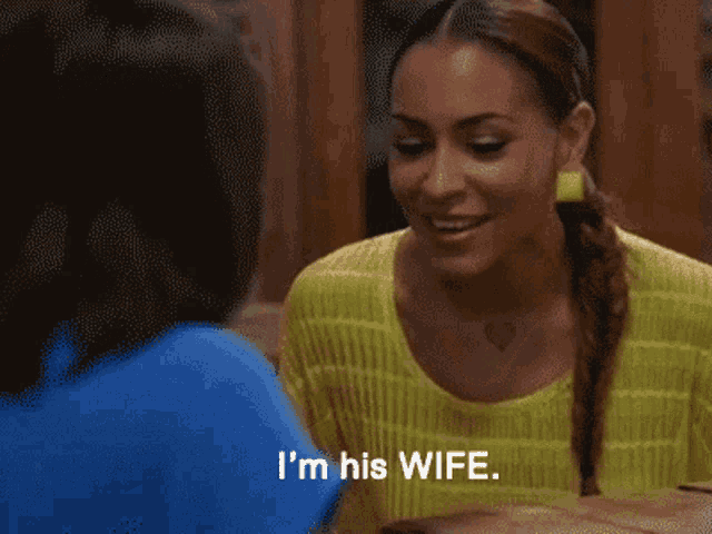 a woman says i 'm his wife while sitting at a table