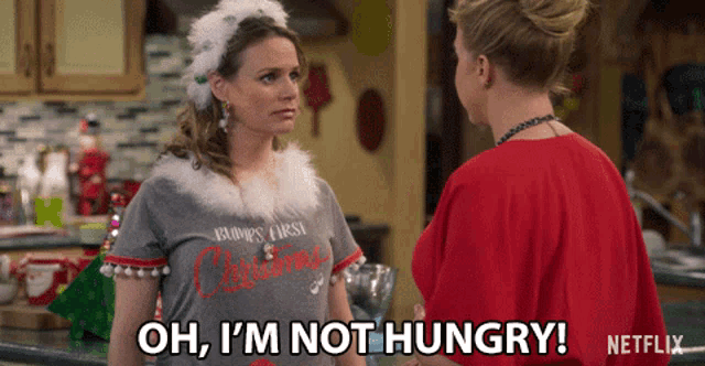 a woman says oh i 'm not hungry while another woman looks on